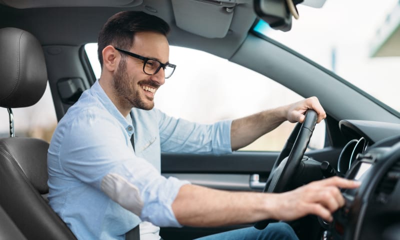 A man in his car using the GPS